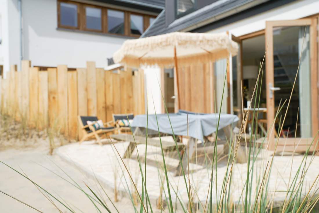 Terrace with parasol seen through the marram grass